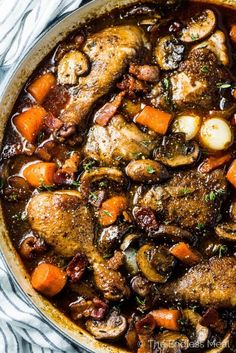 a pot filled with meat and vegetables on top of a table