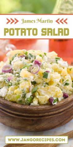 a wooden bowl filled with potato salad on top of a table