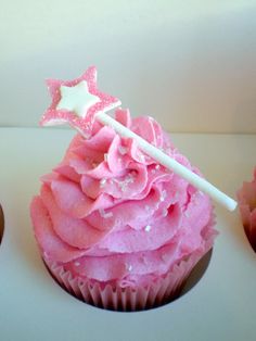 a cupcake with pink frosting and stars on top