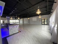 an empty dance floor with lights hanging from the ceiling