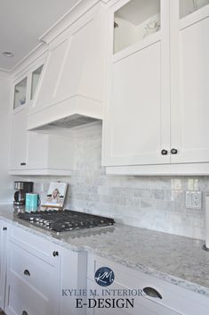 a kitchen with white cabinets and marble counter tops is pictured in this image from the front view