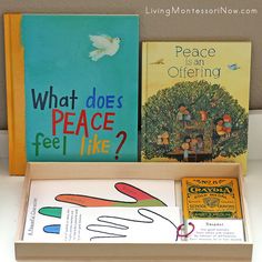 three books in a wooden box on top of a table