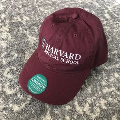 the harvard medical school hat is laying on the floor in front of a gray carpet