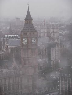 the big ben clock tower towering over the city of london on a foggy day