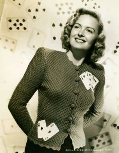 a woman standing in front of playing cards