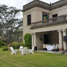 a large house with lawn furniture in front of it