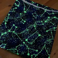 glow in the dark fabric with stars and lines on it, sitting on a wooden floor