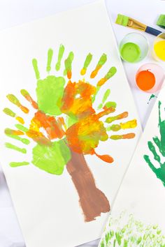 two children's handprints on paper with paint