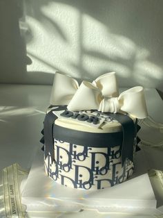 a black and white cake with a bow on top