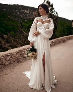 a woman in a white dress standing on a road