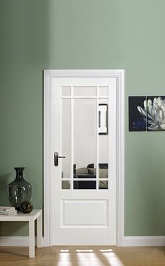 a room with green walls and white doors