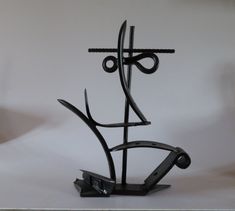 a metal sculpture is shown on a white background with an abstract design in the middle