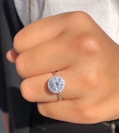 a woman's hand with a diamond ring on it