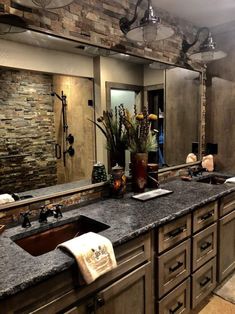 a bathroom with two sinks and a large mirror over it's counter top area