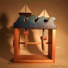 a wooden sculpture with three boats on it