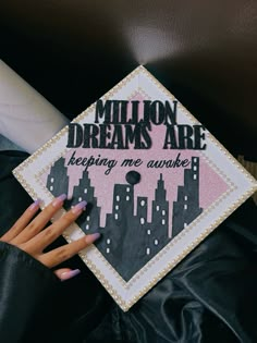 a graduation cap that says million dreams are keeping me awake