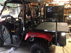 a red utility vehicle parked in a garage