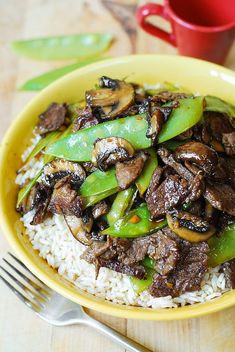 a yellow plate topped with rice and beef