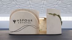 the entrance to asfour crystal is decorated with greenery and white marble pillars