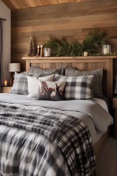 a bed with plaid comforter and pillows in a bedroom next to a wooden wall