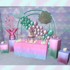 a table topped with lots of different types of cakes and candy bars covered in mermaid themed decorations