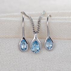 Elegant pear topaz in a rubover setting. Pendant on a chain and matching dangle earrings. Natural African blue topaz 6mm long by 4mm in pendant and 5 x 3mm in each dangle earring giving a total carat weight of 1ct. Topaz are associated with love, self esteem and good fortune. They are the birthstone for December. This elegant necklace and earring set is suitable to wear for daytime or evening wear. It is supplied on a 18 inch sterling silver chain. The pendant, chain and earrings are finished wi Pear-shaped Blue Topaz Jewelry As A Gift, Pear Shaped Blue Topaz Jewelry For Gifts, Pear Shaped Blue Topaz Jewelry Gift, Pear-shaped Blue Topaz Jewelry For Gifts, Teardrop Blue Topaz Jewelry In White Gold, Teardrop Blue Topaz White Gold Jewelry, White Gold Teardrop Blue Topaz Jewelry, Silver Pear-shaped Blue Topaz Jewelry, Topaz Necklace