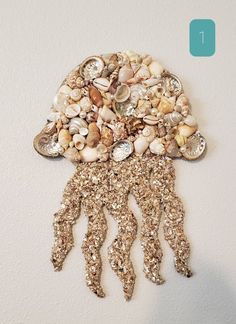 a wall hanging made out of shells and seashells