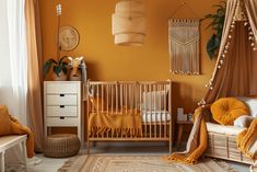 a baby's room with an orange wall and white furniture, including a crib