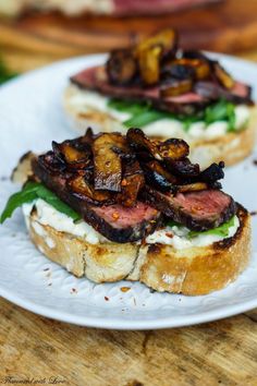 two pieces of bread with meat and vegetables on it