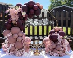 a table topped with lots of balloons and flowers