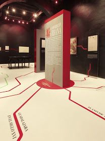 an exhibit with red and white lines on the floor