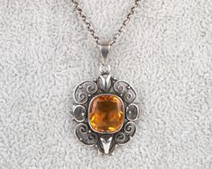 Beautiful Arts and crafts silver and citrine pendant in excellent condition complete with the original chain fitted with a T-bar clasp typical of the period, circa 1910.  This has been left in its original uncleaned condition and has very nice patination. Pendant measures 3.5cm (1.5 ins) from the top of the bale. Chain measures 40.5 cm (16 ins). The pendant and chain are unmarked but test as silver. I am happy to ship worldwide and happy to combine shipping/postage. Please email if you have any Antique Silver Citrine Jewelry, Vintage Amber Sterling Silver Necklace, Victorian Hallmarked Citrine Jewelry, Citrine Pendant, Pendant Necklaces, Citrine, Beautiful Art, Jewelry Necklace Pendant, Necklace Lengths