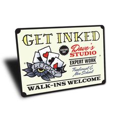 a sign that says get inked with playing cards