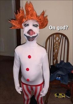 a person in a clown costume standing next to a chair