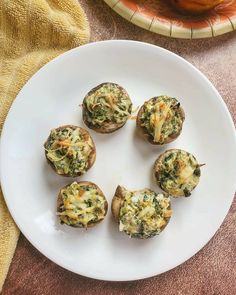 four small muffins on a white plate