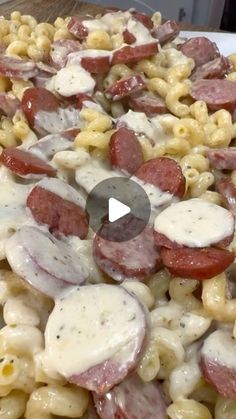 a pizza with sausage and macaroni salad on the side is shown in this video