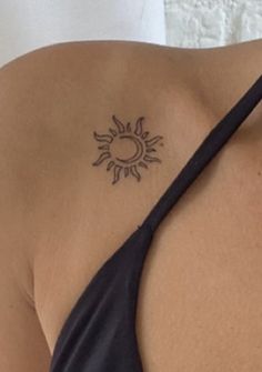 a woman with a sun tattoo on her shoulder