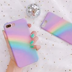 a woman's hand holding an iphone case with rainbow colors