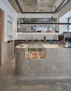 a kitchen with an island counter and wooden cutting boards