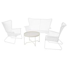 three white wicker chairs and a round table