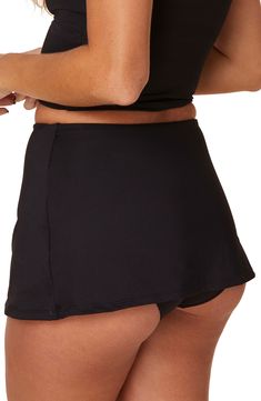 These vintage-inspired bikini bottoms have seriously cute full coverage with a dainty skirt all around. 11 1/2" length (size Medium)   Lined   Full coverage back   80% recycled nylon, 20% spandex   Hand wash, dry flat   Imported Black Summer Swim Skirt With Built-in Shorts, Black Swim Skirt With Built-in Shorts For Vacation, Beachwear Bottoms With Built-in Bra For Beach Season, Black Bottoms With Built-in Shorts For Pool, Solid Swim Skirt With Built-in Bra For Pool, Stretch Swim Dress With Built-in Shorts For Beach, Fitted Swimwear With Built-in Bra And Short Length, Short Swim Skirt With Built-in Shorts For Beachwear, Beachwear Swim Skirt With Built-in Shorts