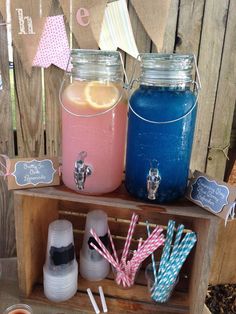 two mason jars filled with drinks sitting on top of a wooden shelf next to each other