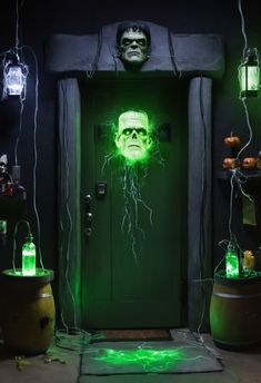 a green door decorated with halloween decorations and lights in the shape of a man's head