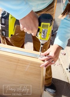 a person using a power drill on wood