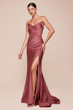 The Ava Gown showcases a strapless pointed V-neckline, a gathered waist, and a stylish leg slit, creating an elegant silhouette. Crafted from stretch spandex satin, it ensures a flawless fit with a lace-up corset back closure. Perfect for bridesmaids, wedding guests, and formal occasions, this dress radiates sophistication. -Silhouette: Fitted -Design: Strapless pointed V-neckline, gathered waistline, leg slit -Fabric & Material: Stretch spandex satin -Fit Detail: Fitted with lace-up corset back Fitted Gowns, Colorful Dresses Formal, Cinderella Divine, Satin Evening Dresses, Corset Back, Evening Dresses Cocktail, Usa Dresses, Gown Prom, Stunning Gowns