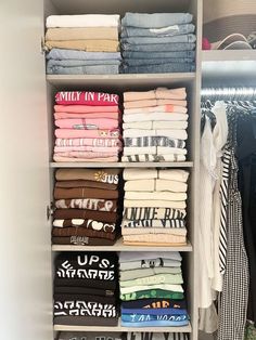 an organized closet with folded clothes and t - shirts