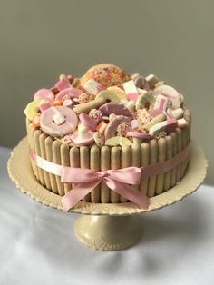 there is a cake decorated with candies and donuts on the top of it