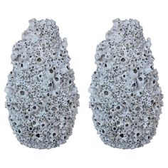 two pairs of shoes made out of rocks on a white background with no people in it