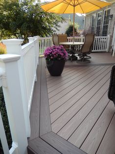 a deck with chairs and an umbrella on it