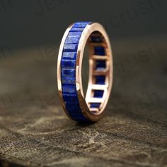 a gold ring with blue lapis inlays